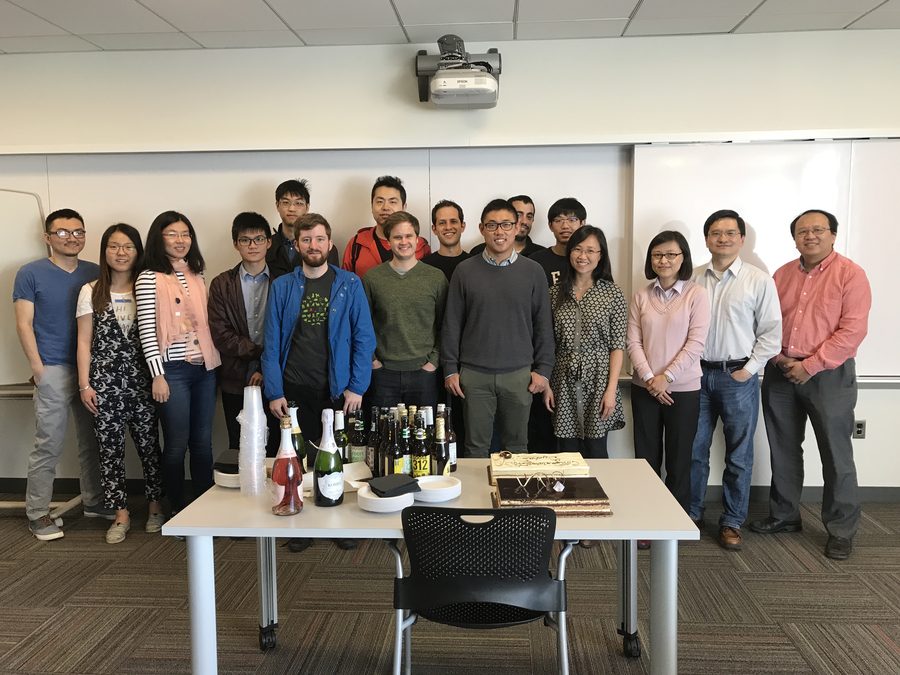 A large group gathered in a conference room for a celebration