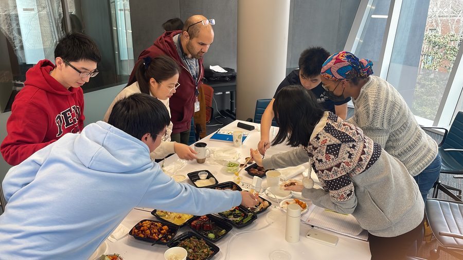 Lab members serving food around a table