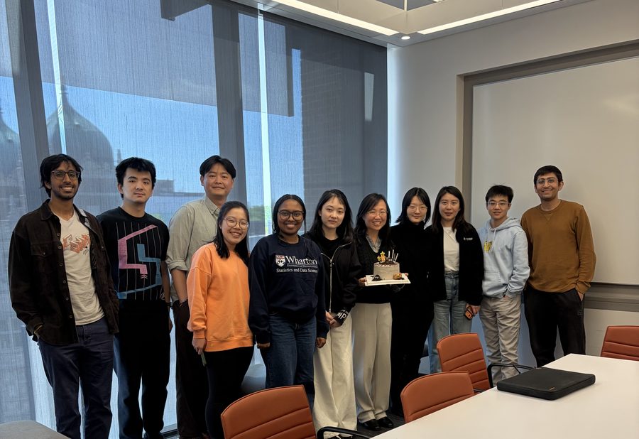 The lab gathered in a seminar room around a cake