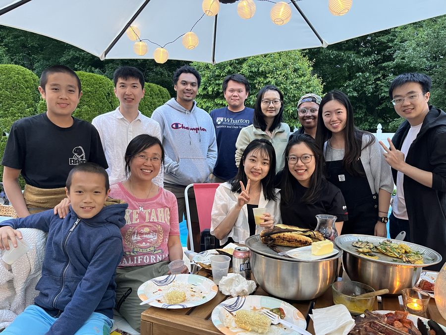 An evening lab gathering outdoors under string lights