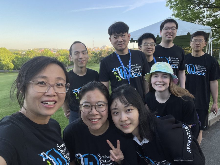 Lab members in matching Section on Statistics in Genomics shirts at sunset